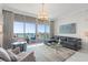 Bright living room featuring modern decor, comfortable seating, and large windows that offer expansive marina views at 1155 N Gulfstream Ave # 706, Sarasota, FL 34236