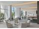 A community lounge area that has comfortable seating, a bar, and floor to ceiling windows that bring in plenty of natural light at 1155 N Gulfstream Ave # 706, Sarasota, FL 34236
