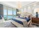 Inviting main bedroom boasts a beautiful water view, elegant chandelier, and comfortable furnishings at 1155 N Gulfstream Ave # 706, Sarasota, FL 34236