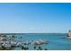 Expansive view of a marina filled with docked boats, set against a clear blue sky and distant cityscape at 1155 N Gulfstream Ave # 706, Sarasota, FL 34236