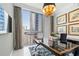 Office with large window, cityscape view, and gold-accented desk and chandelier at 1155 N Gulfstream Ave # 706, Sarasota, FL 34236