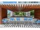 Outdoor kitchen and bar area with ample seating, perfect for entertaining guests in a relaxed setting at 1155 N Gulfstream Ave # 706, Sarasota, FL 34236