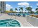 Stunning pool area with blue lounge chairs, hot tub and lush landscaping, perfect for relaxation and entertainment at 1155 N Gulfstream Ave # 706, Sarasota, FL 34236