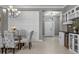 Stylish dining area with modern decor, elegant chairs and beautiful chandelier lighting at 11707 Gramercy Park Ave, Bradenton, FL 34211