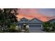 Charming single-Gathering home with a well-manicured lawn and beautiful landscaping at sunset at 11707 Gramercy Park Ave, Bradenton, FL 34211