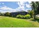 Exterior view of the home with a large screened-in patio, showcasing the manicured lawn and landscaping at 11707 Gramercy Park Ave, Bradenton, FL 34211