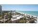 Breathtaking aerial view of a pristine beachfront, lush greenery, and stunning ocean views at 1212 Benjamin Franklin Dr # 901, Sarasota, FL 34236