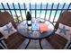Oceanfront balcony with seating, table set for two, and beautiful water views at 1212 Benjamin Franklin Dr # 901, Sarasota, FL 34236