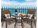 Relax on this condo balcony and enjoy ocean views while seated at the table with seating for two at 1212 Benjamin Franklin Dr # 901, Sarasota, FL 34236