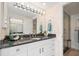 Well-lit bathroom featuring granite countertops, ample storage, and a seamless glass shower enclosure at 1212 Benjamin Franklin Dr # 901, Sarasota, FL 34236