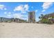 Beautiful beachfront condo with pristine sands, palm trees, and clear blue skies offering a serene coastal living experience at 1212 Benjamin Franklin Dr # 901, Sarasota, FL 34236