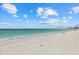 Expansive white sand beach with clear turquoise water and blue skies, ideal for relaxation at 1212 Benjamin Franklin Dr # 901, Sarasota, FL 34236