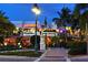 Evening view of the iconic Columbia Restaurant and shops, highlighted by lush greenery and soft lighting at 1212 Benjamin Franklin Dr # 901, Sarasota, FL 34236