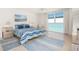 This main bedroom has large windows overlooking the beach, a queen-sized bed, and tile flooring at 1212 Benjamin Franklin Dr # 901, Sarasota, FL 34236
