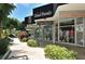 Sidewalk view of shops and boutiques along a beautifully landscaped street on a sunny day at 1212 Benjamin Franklin Dr # 901, Sarasota, FL 34236