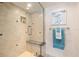Elegant walk-in shower with built-in seat and niche, complemented by neutral tile and stylish fixtures at 1212 Benjamin Franklin Dr # 901, Sarasota, FL 34236