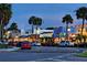 Charming street view of shops and restaurants at twilight with palm trees and street lights at 1212 Benjamin Franklin Dr # 901, Sarasota, FL 34236