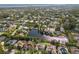 Stunning aerial view of a residential community with lush landscaping, serene ponds, and beautiful waterways nearby at 1217 92Nd Nw St, Bradenton, FL 34209