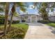 Inviting single-story home with well-maintained lawn, mature palm trees, and spacious driveway at 1217 92Nd Nw St, Bradenton, FL 34209