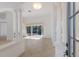Bright foyer with tiled floor, white pillars, and view of the pool through sliding glass doors at 1217 92Nd Nw St, Bradenton, FL 34209