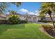 Beautiful single-story home with lush green lawn, well-manicured bushes, and neutral color palette at 1217 92Nd Nw St, Bradenton, FL 34209
