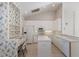 Bright eat-in kitchen with white cabinetry, island, and floral wallpaper accents at 1217 92Nd Nw St, Bradenton, FL 34209