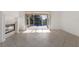 Bright living room with fireplace, tiled floors, and sliding glass doors overlooking the pool at 1217 92Nd Nw St, Bradenton, FL 34209