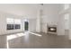 Open living room with fireplace, large windows, and access to outdoor space at 1217 92Nd Nw St, Bradenton, FL 34209