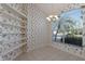 Bright office space with floral wallpaper, built-in shelves, a chandelier and ample natural light at 1217 92Nd Nw St, Bradenton, FL 34209