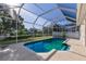 Sparkling pool with screened-in enclosure and lush landscaping at 1217 92Nd Nw St, Bradenton, FL 34209