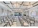 Bright ballroom offers a beautiful event space with rows of seating, modern lighting, and ocean views at 1281 Gulf Of Mexico Dr # 906, Longboat Key, FL 34228