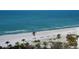 Stunning beach with lounge chairs and umbrellas is the perfect relaxation spot with palm trees surrounding the area at 1281 Gulf Of Mexico Dr # 906, Longboat Key, FL 34228