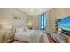 Cozy bedroom featuring lots of natural light, comfortable furniture, and beachfront view at 1281 Gulf Of Mexico Dr # 906, Longboat Key, FL 34228