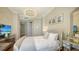 Cozy bedroom featuring a plush bed, modern lighting, and stylish mirrored furniture at 1281 Gulf Of Mexico Dr # 906, Longboat Key, FL 34228