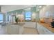 Bright kitchen features custom white cabinetry, granite countertops, and modern stainless appliances at 1281 Gulf Of Mexico Dr # 906, Longboat Key, FL 34228