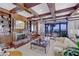 Traditional living room boasts detailed millwork, coffered ceilings, fireplace, and large window overlooking the ocean at 1281 Gulf Of Mexico Dr # 906, Longboat Key, FL 34228