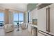 Bright breakfast area with a desk, comfortable chairs, and a captivating ocean view from large windows at 1281 Gulf Of Mexico Dr # 906, Longboat Key, FL 34228