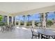 A covered patio is nicely arranged with several tables to take in the views of the ocean and surrounding greenery at 1281 Gulf Of Mexico Dr # 906, Longboat Key, FL 34228