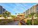 Exterior walkway offers scenic views of the luxurious beachfront condominiums and lush landscaping at 1281 Gulf Of Mexico Dr # 906, Longboat Key, FL 34228