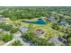Expansive aerial view of the property, backing onto a serene pond with lush landscaping and mature trees at 13625 3Rd Ne Ave, Bradenton, FL 34212