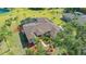 Aerial view showcases home with inviting screened pool and surrounding lush landscaping at 13625 3Rd Ne Ave, Bradenton, FL 34212