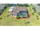 Aerial view of a home featuring a screened pool, well-manicured landscaping and a spacious driveway at 13625 3Rd Ne Ave, Bradenton, FL 34212