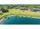 Aerial view showing large yard, screened pool, pond and neighboring houses at 13625 3Rd Ne Ave, Bradenton, FL 34212