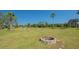 Spacious backyard with a fire pit and play area, ideal for Gathering fun and relaxation at 13625 3Rd Ne Ave, Bradenton, FL 34212