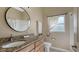 Bathroom featuring granite counters, updated fixtures, and natural light from the window at 13625 3Rd Ne Ave, Bradenton, FL 34212