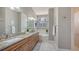 Bright bathroom featuring double sinks, granite countertops, a bathtub, and modern finishes at 13625 3Rd Ne Ave, Bradenton, FL 34212