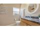 Bathroom featuring granite counters, updated fixtures, and natural light from the window at 13625 3Rd Ne Ave, Bradenton, FL 34212