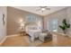 Cozy bedroom with an arched window above the bed, wood floors and neutral decor at 13625 3Rd Ne Ave, Bradenton, FL 34212