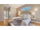 Bright bedroom features a stylish bed, arched window, and sleek, modern decor at 13625 3Rd Ne Ave, Bradenton, FL 34212