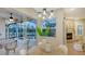 Dining area with view of pool and lanai, and modern chandelier-style lighting at 13625 3Rd Ne Ave, Bradenton, FL 34212